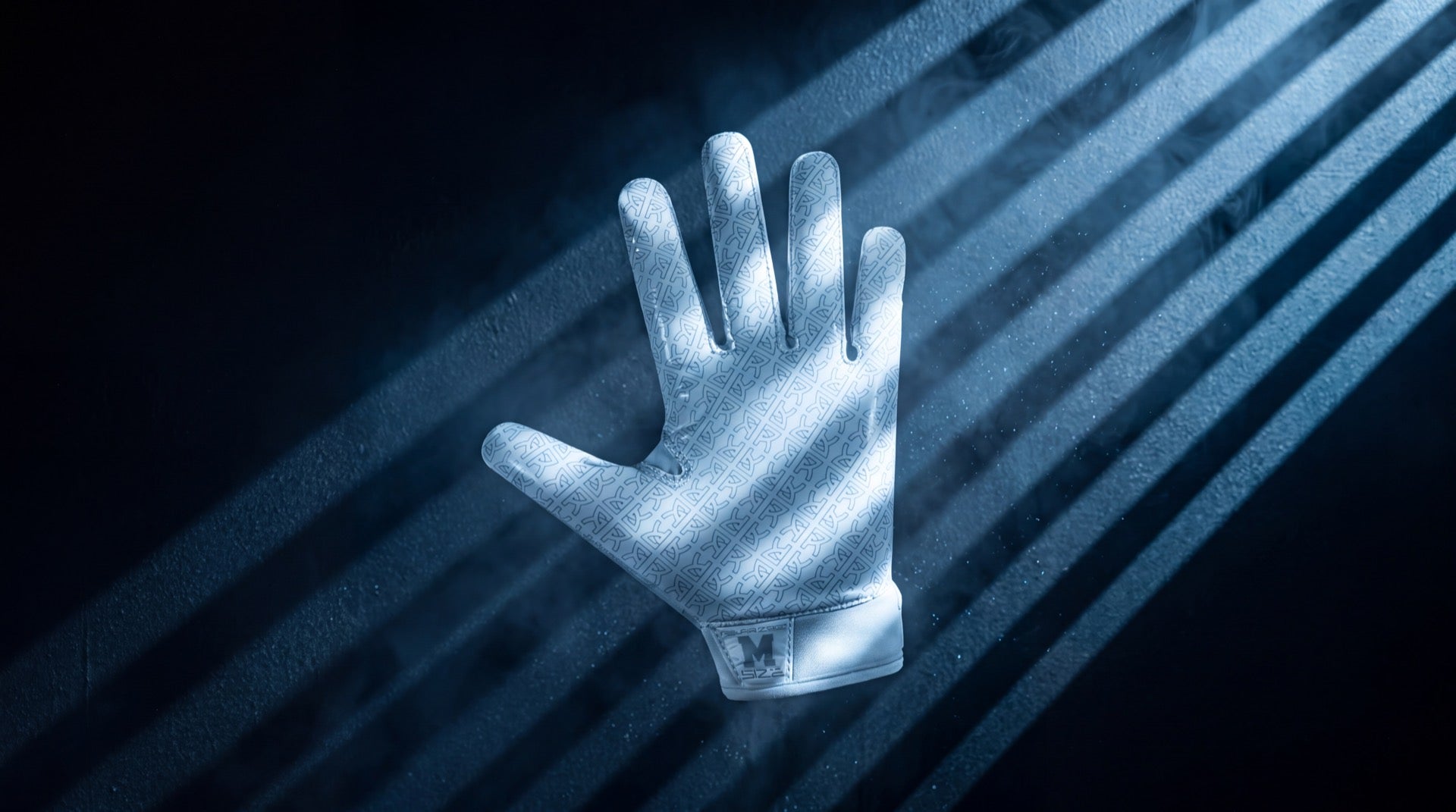 White Reyrr ZERO football glove with monogram grip pattern floating in cold blue gobo light